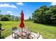 Spacious backyard with lush green grass and a patio set, perfect for outdoor entertaining at 4732 Gibbons Link Rd, Charlotte, NC 28269