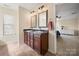 Elegant bathroom boasts a double vanity with granite countertops and decorative mirrors at 4732 Gibbons Link Rd, Charlotte, NC 28269