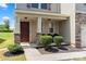 Inviting front porch with stone accents, landscaping, and a cozy seating area at 4732 Gibbons Link Rd, Charlotte, NC 28269
