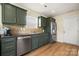 Well-appointed kitchen features stainless steel appliances, stylish cabinets, and modern flooring at 4732 Gibbons Link Rd, Charlotte, NC 28269