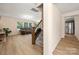 Cozy living room with comfortable sofa and large windows next to the stairs and kitchen at 4732 Gibbons Link Rd, Charlotte, NC 28269