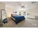 Spacious main bedroom features a comfortable bed, modern decor, and a large window view at 4732 Gibbons Link Rd, Charlotte, NC 28269