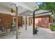 Spacious covered back deck with patio seating area and brick home exterior at 5008 Saddle Horn Trl, Weddington, NC 28104