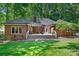 Lovely brick home back exterior view with a large deck, perfect for outdoor entertaining and overlooking the backyard at 5008 Saddle Horn Trl, Weddington, NC 28104