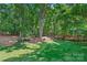 Lush backyard with mature trees and expansive lawn, perfect for outdoor enjoyment at 5008 Saddle Horn Trl, Weddington, NC 28104
