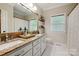 Bathroom with double sink vanity, granite counters, and large mirror at 5008 Saddle Horn Trl, Weddington, NC 28104