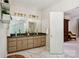 Bathroom featuring double sinks, marble counters, and gold fixtures at 5008 Saddle Horn Trl, Weddington, NC 28104