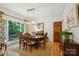 Elegant dining room featuring a large window, stylish chandelier, and classic wooden furniture at 5008 Saddle Horn Trl, Weddington, NC 28104