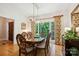 Bright dining area with hardwood floors, large window, and a stylish rectangular chandelier at 5008 Saddle Horn Trl, Weddington, NC 28104
