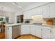 Well-lit kitchen featuring stainless steel appliances, white cabinets, hardwood floors and granite countertops at 5008 Saddle Horn Trl, Weddington, NC 28104