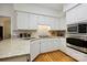 Bright kitchen featuring stainless steel appliances, white cabinets, hardwood floors and granite countertops at 5008 Saddle Horn Trl, Weddington, NC 28104