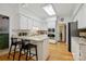 Bright kitchen features white cabinetry, granite countertops, stainless steel appliances, and an island with bar seating at 5008 Saddle Horn Trl, Weddington, NC 28104