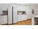 Spacious kitchen featuring white cabinets, granite countertops, stainless steel appliances, and hardwood flooring at 5008 Saddle Horn Trl, Weddington, NC 28104