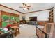 Bright living room with large windows, comfortable seating, wood trim, built-in shelving, and carpeted floors at 5008 Saddle Horn Trl, Weddington, NC 28104