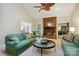 Inviting living room with a brick fireplace, vaulted ceiling, and comfortable green sofas at 5008 Saddle Horn Trl, Weddington, NC 28104