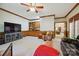 Spacious carpeted living room with wood-paneled walls, ceiling fan, entertainment center, and comfortable seating at 5008 Saddle Horn Trl, Weddington, NC 28104