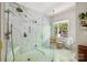 This luxurious shower features sleek fixtures, marble tile, and glass enclosure at 5008 Saddle Horn Trl, Weddington, NC 28104