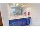 The bathroom features a double vanity with bright lights, neutral paint and silver hardware at 6313 Woodland Commons Dr, Charlotte, NC 28269