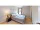 Neutral bedroom features a bed, lamp, side table, and art prints hanging on the wall at 6313 Woodland Commons Dr, Charlotte, NC 28269