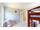 A room features a bunk bed, neutral paint, and natural light from a large window at 6313 Woodland Commons Dr, Charlotte, NC 28269