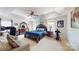 This primary bedroom features a sitting area, a ceiling fan, and is naturally lit from two large windows at 6313 Woodland Commons Dr, Charlotte, NC 28269