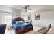 This primary bedroom features a sitting area, a ceiling fan, and is naturally lit from two large windows at 6313 Woodland Commons Dr, Charlotte, NC 28269