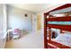 Bedroom with bunkbeds, white walls, a pink desk set and a peek into the hallway at 6313 Woodland Commons Dr, Charlotte, NC 28269