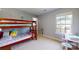 Bright bedroom with a bunk bed, desk and chair, plus whimsical decorative wall art at 6313 Woodland Commons Dr, Charlotte, NC 28269