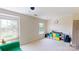 Spacious bonus room featuring large windows, green couch, and an array of storage options at 6313 Woodland Commons Dr, Charlotte, NC 28269