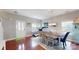 Bright dining area with hardwood floors and a modern chandelier at 6313 Woodland Commons Dr, Charlotte, NC 28269