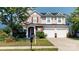 Charming two-story home with a two-car garage and well-manicured lawn at 6313 Woodland Commons Dr, Charlotte, NC 28269