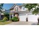 Beautiful home exterior with a two-car garage and stone accents at 6313 Woodland Commons Dr, Charlotte, NC 28269