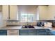 Kitchen featuring a black sink, stainless steel dishwasher, and a window providing natural light above the sink at 6313 Woodland Commons Dr, Charlotte, NC 28269