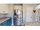 Kitchen features stainless steel refrigerator and lots of cabinet space for storage with blue and white cabinets at 6313 Woodland Commons Dr, Charlotte, NC 28269