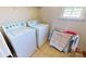 Bright laundry room with a standard washer and dryer and a rack to dry delicate items at 6313 Woodland Commons Dr, Charlotte, NC 28269