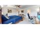 Well-lit primary bedroom with a seating area, large bed, a desk, and a ceiling fan at 6313 Woodland Commons Dr, Charlotte, NC 28269
