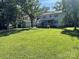 Expansive backyard with a large lawn and mature trees providing ample shade at 6708 Nutcracker Pl, Charlotte, NC 28212