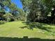 Lush green backyard with mature trees, creating a serene outdoor space at 6708 Nutcracker Pl, Charlotte, NC 28212