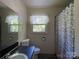 Bathroom featuring a toilet, sink, and shower with gray curtain at 6708 Nutcracker Pl, Charlotte, NC 28212