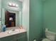 Functional bathroom with a single sink vanity, a large mirror, and a neutral color scheme at 6708 Nutcracker Pl, Charlotte, NC 28212