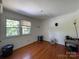 Bedroom with hardwood floors and a window letting in natural light at 6708 Nutcracker Pl, Charlotte, NC 28212