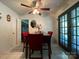 Bright dining area with white tile flooring, a modern light fixture, and access to the outdoors at 6708 Nutcracker Pl, Charlotte, NC 28212