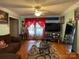 Cozy living room featuring hardwood floors, a ceiling fan, and a large flat-screen television at 6708 Nutcracker Pl, Charlotte, NC 28212