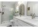 Bright bathroom featuring double sinks, quartz countertops, modern fixtures and a glass-enclosed shower at 7516 O'Hara St, Huntersville, NC 28078