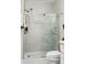 Well-lit bathroom showcases a modern, glass-enclosed shower with white subway tile surround and sleek fixtures at 7516 O'Hara St, Huntersville, NC 28078