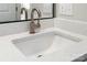 Close-up of a bathroom sink with white countertop and a modern faucet under the mirror at 7516 O'Hara St, Huntersville, NC 28078