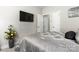 Cozy bedroom with TV, neutral walls, and soft lighting offering a tranquil retreat at 7516 O'Hara St, Huntersville, NC 28078