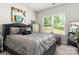 Bedroom showcasing window with bright natural light and stylish accents, creating a comfortable retreat at 7516 O'Hara St, Huntersville, NC 28078