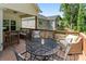 Outdoor deck with patio seating, table, and forested background, perfect for relaxing and entertaining at 7516 O'Hara St, Huntersville, NC 28078