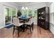 Dining room featuring a dark wood table, modern chairs, and sliding doors to an outdoor deck at 7516 O'Hara St, Huntersville, NC 28078